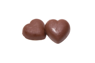 Two chocolate hearts on white background