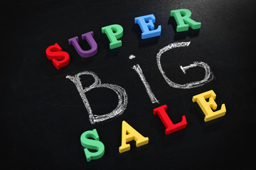 Super big sale concept on a blackboard background