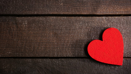 Valentine concept. Heart nailed to wooden background