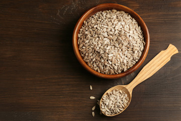 Peeled sunflower seeds on wooden table background, closeup