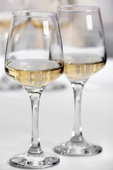 Glasses of white wine on table closeup
