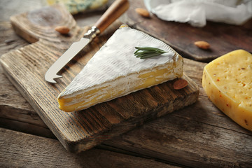 Fototapeta na wymiar Set of cheese on wooden background