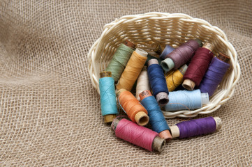Coils with colorful threads in a wicker basket
