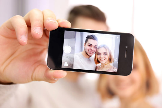 Young Couple In Love Taking Photo Of Their Self With Mobile Phone, Close Up