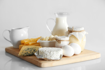 Fototapeta na wymiar Set of fresh dairy products on wooden table, on white background