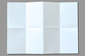 White paper wrinkled crumpled on gray background.