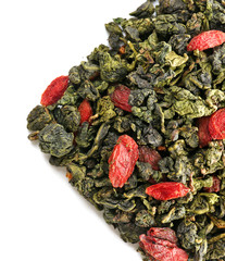 Pile of dry tea with goji berries, isolated on white