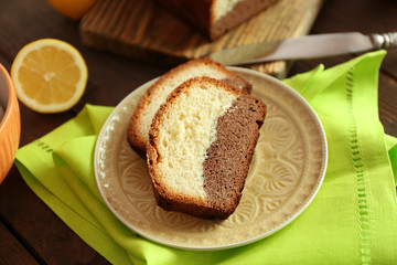 Delicious sweet cake bread in plate on wooden table closeup