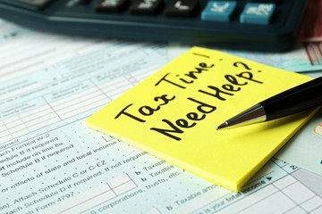 Money concept. Black calculator with cash and documents, close up