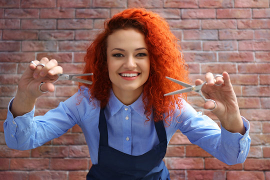 Red haired beautiful girl with scissors