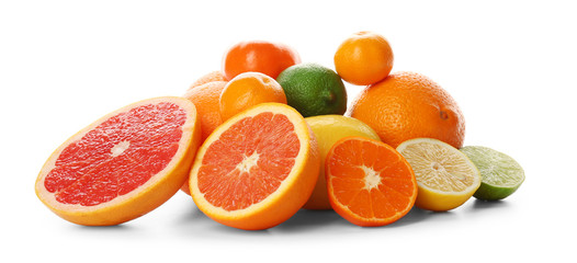 A heap of mixed citrus fruit sliced and unpeeled isolated on a white background, close up