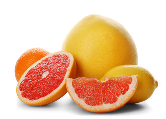 Mixed citrus fruit including lemon, sliced grapefruit, orange and pomelo isolated on a white background, close up