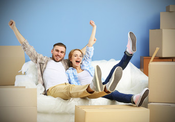 Happy young couple moving in their new apartment