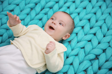 Lovely baby on knitted turquoise background