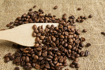 spoon and coffee beans, on the texture of the bag from the fibers