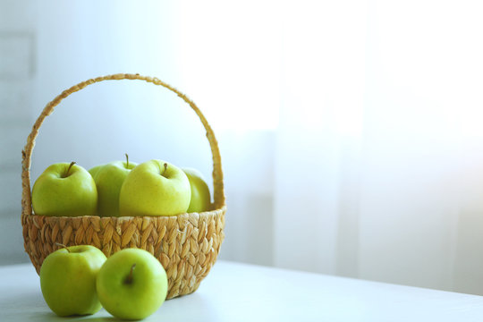 Ripe Green Apples In Basket On A Kitchen Table