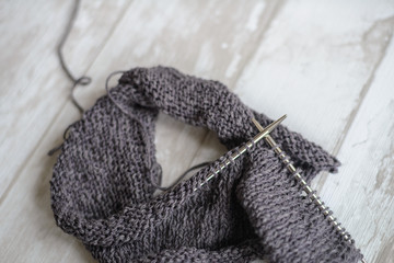 grey yarn and knitting needles