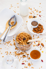 Homemade muesli, honey, nuts and milk. healthy breakfast concept