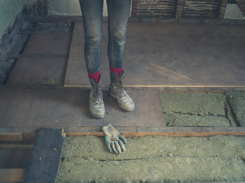 Feet and legs of worker by insulation