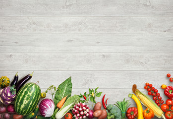 Organic food background. Studio photo of different fruits and vegetables on white wooden table. High resolution product.