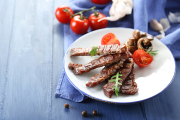 Grilled beef with vegetables on plate