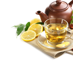 Cup of tea with ginger and cinnamon on napkin isolated on white