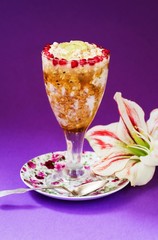 Porridge dessert in glass with honey and pomegranate, flower