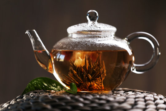 Teapot on a wicker mat on dark background