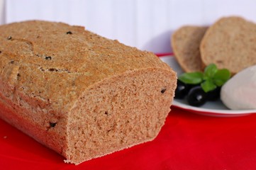 Homebread with mozzarella, basil and olives