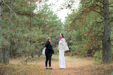 Fototapeta premium Two female tourists walking in the forest