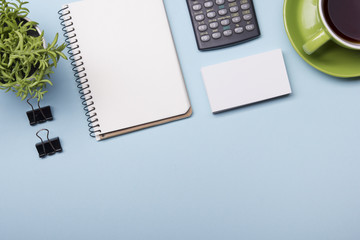 Office table with supply and coffe cup. View from above. Copy space for text