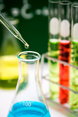 Dropping chemical liquid to flask 