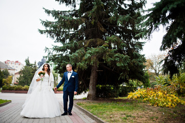 Happy wedding couple in love at autumn park