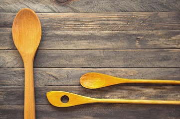 Wooden kitchen spatulas and spoons on a vintage table