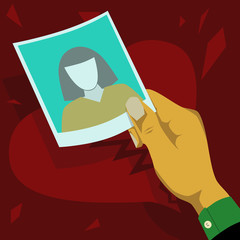 Heartbroken, looking at photos of former lover