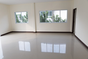 room with sliding window and beige tile floor