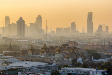 Fototapeta premium Grand Palace and Emerald Buddha Temple (Wat Phra Kaew) at morning sunrise time of winter covered with mist, Bangkok, Thailand