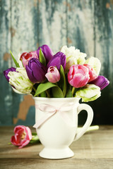 Beautiful tulips bouquet on wooden table