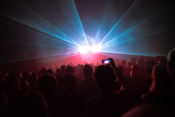 Fototapeta na wymiar Phone in the air at a music concert in a dance club