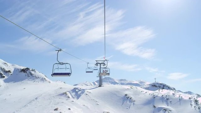 Riding the ski lift in sunny ski resort