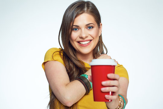 Smiling girl with long hair holding coffee cup.