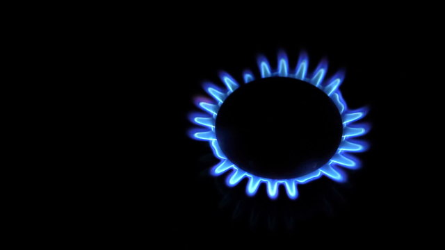 Moving around over kitchen gas stove while burners are turned on