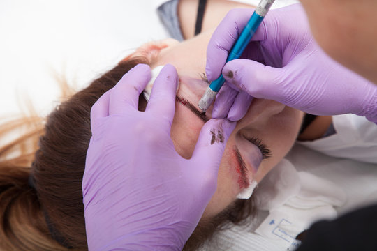 A woman getting permanent make up