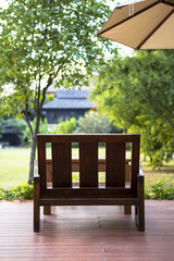 Wooden chair in the green garden