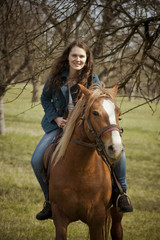 Fototapeta premium Happy woman riding her horse