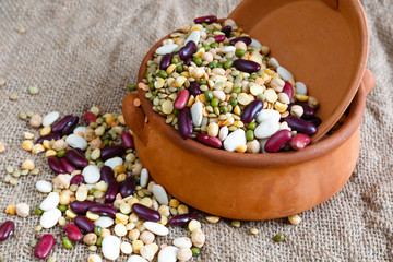 Bean colorful striped beans, peas, soybeans, legumes, seed in ceramic handmade pot