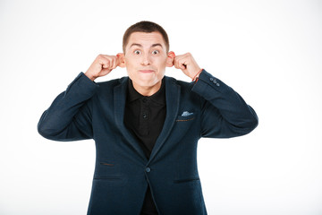 Funny businessman holding his ears