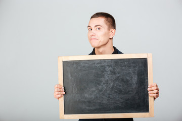 Happy businessman holding blank board