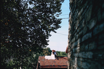 Lovely couple is sitting on the roof