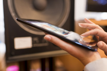 Woman listening music from a tablet Device connected